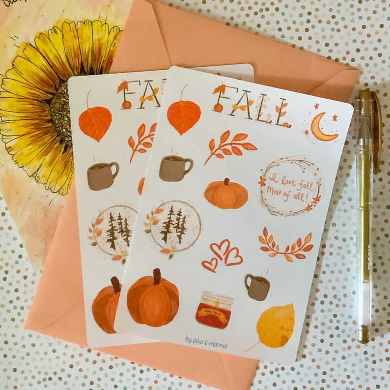 May include: A sheet of fall-themed stickers with illustrations of pumpkins, leaves, coffee cups, a moon, and the words "Fall" and "I love fall most of all!" The stickers are on a white background and have a hand-drawn style.