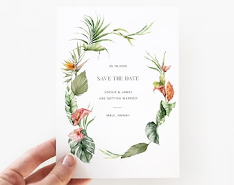 May include: Save the date card with a tropical floral wreath design. The text reads "05.18.2023 Save the Date Sophie & James are getting married Maui, Hawaii"