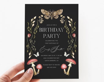 May include: Black and white birthday party invitation with a gold moth, mushrooms, and floral accents. The text reads "Join us for a Birthday Party Celebrating the first birthday of [Name] Saturday, May 23 at 11:30 AM 4045 Celebration Way Santa Barbara, CA Please RSVP to Rachel 805.555.5555"