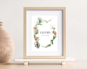 Può includere: Una stampa incorniciata con un'illustrazione ad acquerello di una ghirlanda floreale con foglie verdi e fiori rosa. Il testo "Favors" è al centro della ghirlanda.