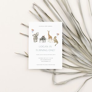 May include: A light blue and white invitation card with a watercolor illustration of a giraffe, zebra, elephant, and lion. The text on the card reads "Calling all party animals! Logan is turning one! Please join us for his birthday party. Saturday, May 22 at 11:00 am. 1025 Celebration Way, Santa Barbara, CA. Please RSVP to Alear at 805.515.3355."