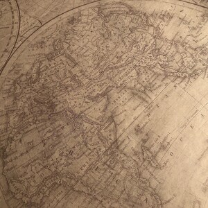 May include: An antique world map printed on aged paper with brown ink. The map shows the continents of North America, South America, Europe, Asia, and Africa. The map is surrounded by a decorative border.