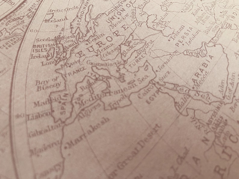 May include: A vintage world map with a focus on Europe, the Mediterranean Sea, and the Middle East. The map is printed in brown ink on a cream-colored background.
