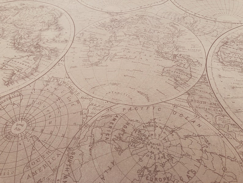 May include: A vintage-style world map printed on a beige background. The map features multiple circular maps of the world, including a polar projection map.