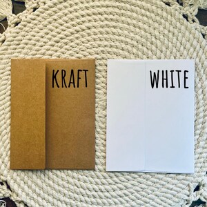 May include: Two envelopes, one brown with the word "KRAFT" printed on it, and one white with the word "WHITE" printed on it.