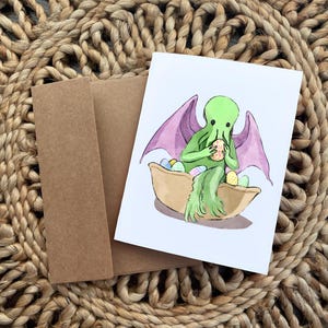 Cute Easter Basket Cthulhu Card - Easter Monster Card Featuring Cthulhu Sitting in an Easter Basket and Holding an Easter Egg