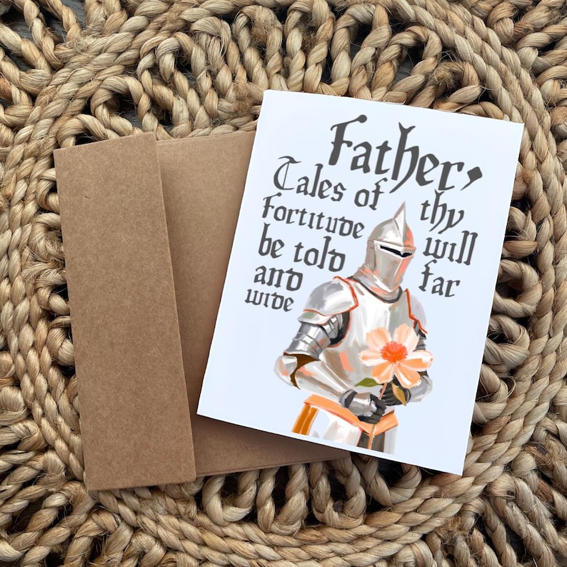 May include: A white card featuring a knight in silver armour holding a pink flower. The card has black text that reads "Father, Tales of thy fortitude will be told far and wide."