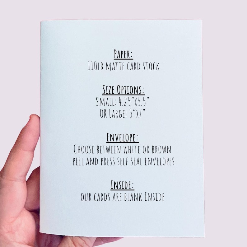 May include: A folded white card with text detailing paper type, size options (4.25"x5.5" or 5"x7"), envelope choices, and that the inside is blank. The card is held by a person's hand.