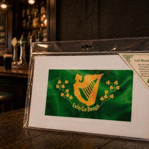May include: An Irish Blessing art print in a clear plastic sleeve. The print features a gold harp and shamrocks on a green background with the words "Erin Go Bragh". A small tag in the upper right corner reads "Irish Blessing".