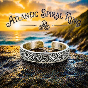 May include: A silver-colored ring with an open design, featuring an intricate spiral pattern. The ring is marked with "925" and is set against a beach scene with the text "Atlantic Spiral Ring".