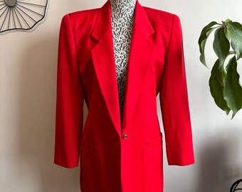 May include: A bright red blazer with a single button closure and a classic notched lapel. The blazer has a tailored fit and is made of a smooth, lightweight fabric.