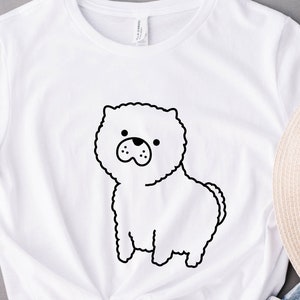 May include: White t-shirt with a black line drawing of a fluffy dog on the front.
