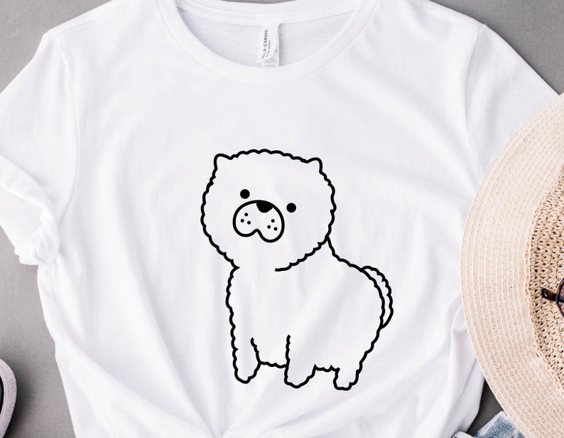 May include: White t-shirt with a black line drawing of a fluffy dog on the front.
