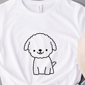 May include: White t-shirt with a black line drawing of a fluffy dog on the front.