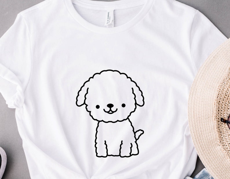 May include: White t-shirt with a black line drawing of a fluffy dog on the front.