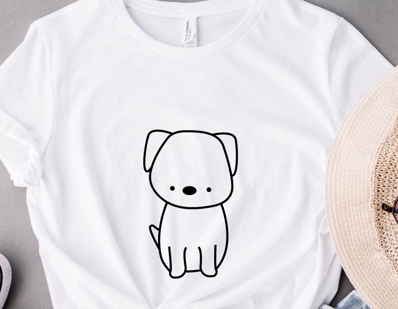 May include: White t-shirt with a black line drawing of a dog on the front.
