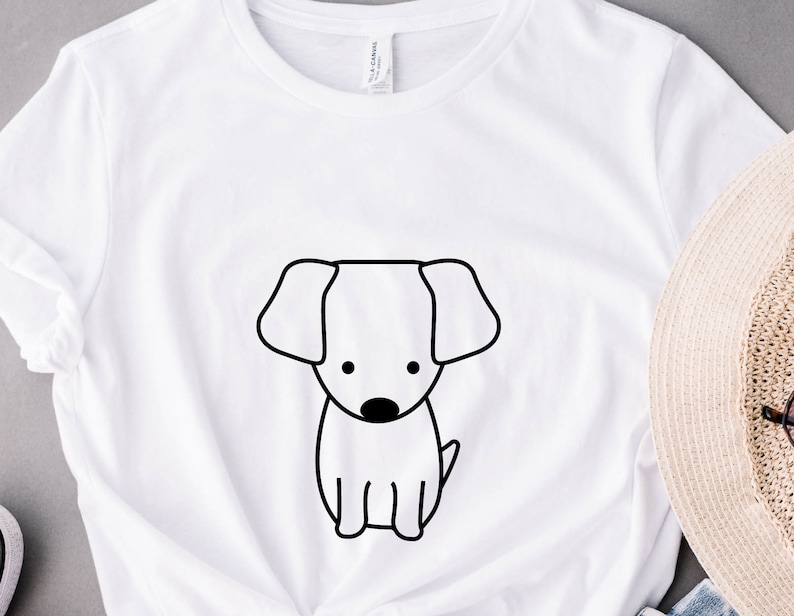 May include: White t-shirt with a black line drawing of a dog on the front.