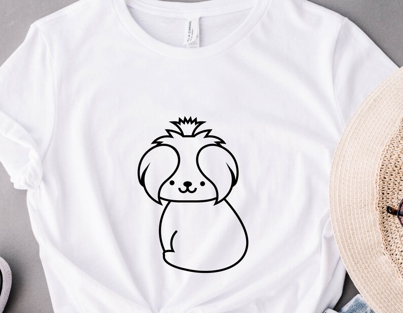May include: White t-shirt with a black line drawing of a Shih Tzu dog.