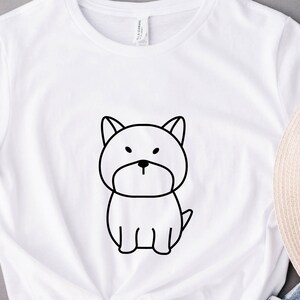 May include: White t-shirt with a black line drawing of a dog on the front.