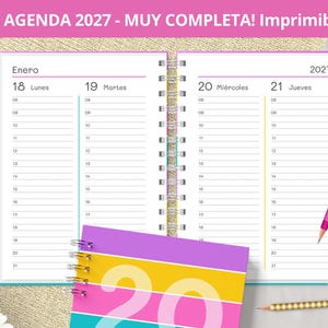 May include: A spiral-bound 2027 planner open to a daily view for January 18 through January 21. The pages feature hourly time slots from 06 to 21. A separate cover shows the year 2027 in large white font over horizontal purple, yellow, and pink stripes.