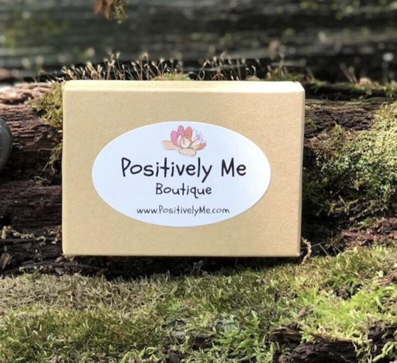 May include: A brown cardboard box with a white oval sticker that says "Positively Me Boutique" and "www.PositivelyMe.com".