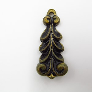 Könnte beinhalten: Ein schwarzer und goldener Metallanhänger in Blattform mit einem dekorativen Design. Der Anhänger hat oben ein Loch zum Aufhängen.