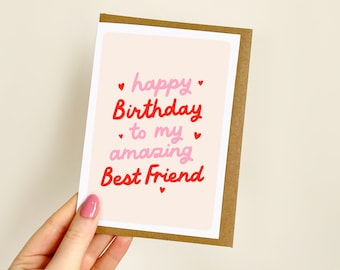 May include: A birthday card with a light pink background and the words "happy Birthday to my amazing Best Friend" in red and pink lettering. Small red hearts are scattered around the text. The card has a brown border.