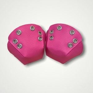 Peut inclure: Paire de protège-orteils de patins à roulettes rose vif. Chaque protège-orteil est fait d'un matériau texturé et comporte plusieurs œillets argentés pour la fixation. Les protège-orteils sont conçus pour protéger les orteils des patins à roulettes.