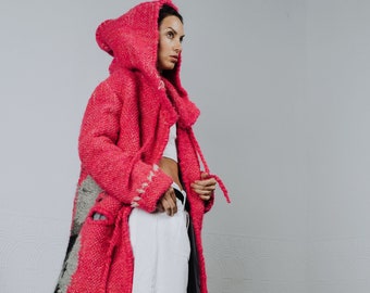 Pink women's coat with hood and embroidery pattern made from sheep's wool. Oversized fuchsia coat