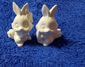 Two ceramic unpainted bunnies