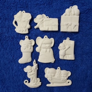 May include: Set of nine white ceramic Christmas ornaments featuring various mouse designs. The ornaments include a mouse holding a present, a mouse riding a sleigh, a mouse holding a stocking, and a mouse holding a candle.