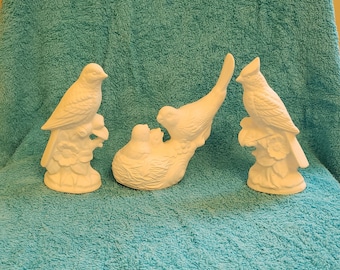 Various unpainted ceramic birds