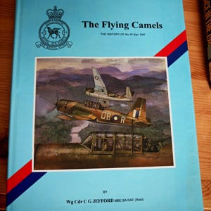 May include: A light blue hardback book titled The Flying Camels: The History of No 45 Sqn, RAF by Wg Cdr C G Jefford. The cover features the Royal Air Force squadron crest and a painting of military aircraft flying over a landscape.