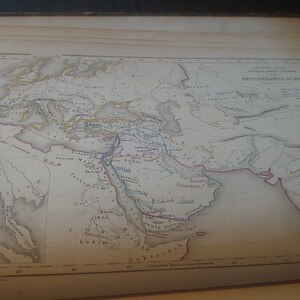 May include: A vintage map depicting the "Geography of Persia" with various colored lines and text labels. The map shows the geographical features of Persia, including rivers, mountains, and cities. The map is printed on a cream-colored paper and has a faded appearance.