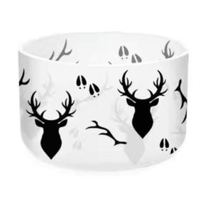 May include: A white ceramic bowl with a black deer silhouette and hoof print pattern. The bowl has a rounded shape and is suitable for serving food or as a decorative piece. The deer design adds a rustic touch.