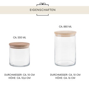 May include: Two clear glass jars with wooden lids. The smaller jar holds approximately 530 ml and is 10 cm in diameter and 10.6 cm high. The larger jar holds approximately 880 ml and is 10 cm in diameter and 16 cm high. The word "EIGENSCHAFTEN" is at the top.
