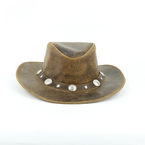 May include: A brown leather cowboy hat with silver concho accents.