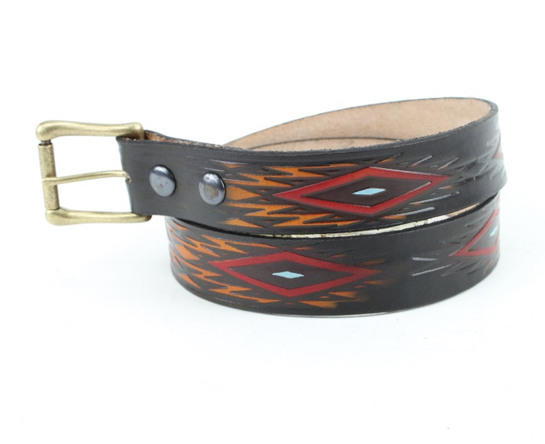 May include: A brown leather belt with a brass buckle and a geometric pattern in red, orange, and blue.