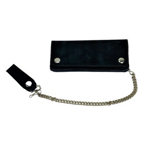 May include: A black leather wallet with a silver chain attached. The wallet has two silver snaps on the front.