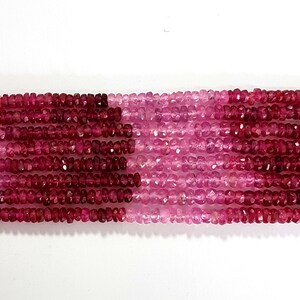 May include: A strand of pink and red faceted gemstone beads. The beads are small and have a slightly irregular shape. The strand is approximately 16 inches long.