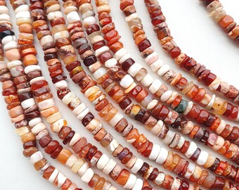 May include: Strands of gemstone beads in shades of red, orange, brown, and cream. The beads are small, flat, and irregularly shaped, strung together to form necklaces. The color variations create a natural, earthy aesthetic, suitable for jewelry making.