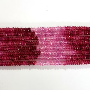 May include: A strand of pink and red faceted gemstone beads. The beads are small and have a slightly irregular shape. The strand is approximately 16 inches long.