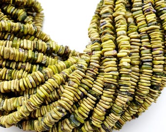 May include: Close-up of a pile of olive-green, rectangular beads. The beads are stacked together, creating a textured surface. The beads have a slightly irregular shape and a matte finish. The background is white.