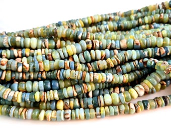 May include: A strand of green, blue, and yellow gemstone beads. The beads are irregular in shape and have a smooth, polished finish.
