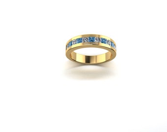 Può includere: Un anello a fascia d'oro con una fila di pietre blu e bianche.