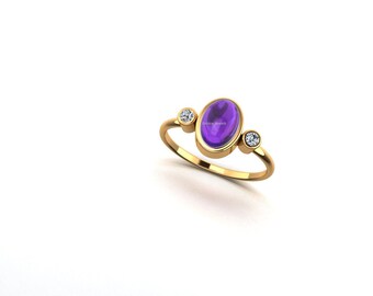 May include: A gold ring featuring a large oval amethyst gemstone and two smaller round diamonds.