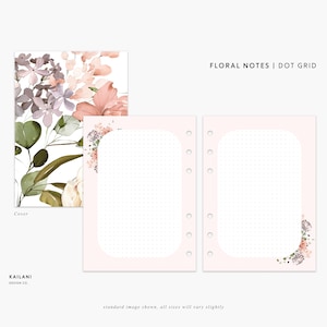 May include: Floral notes dot grid notebook cover with a pink and white floral design. The cover features a watercolor style floral pattern with pink, white, and green hues. The text "FLORAL NOTES | DOT GRID" is printed in black at the top of the cover.