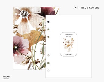 May include: A white planner cover with a floral design featuring watercolour-style flowers in shades of brown, pink, and white. The cover also includes a text box with the words "Les Fleurs no. one" and "January".