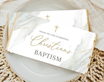 May include: White and gold marble-patterned chocolate bar wrapper with the text "Thank you for celebrating Christian's Baptism" and two gold crosses.