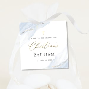 May include: A white favour bag with a blue and gold watercolour design tag. The tag says "Thank you for celebrating Christian's Baptism January 22, 2024".